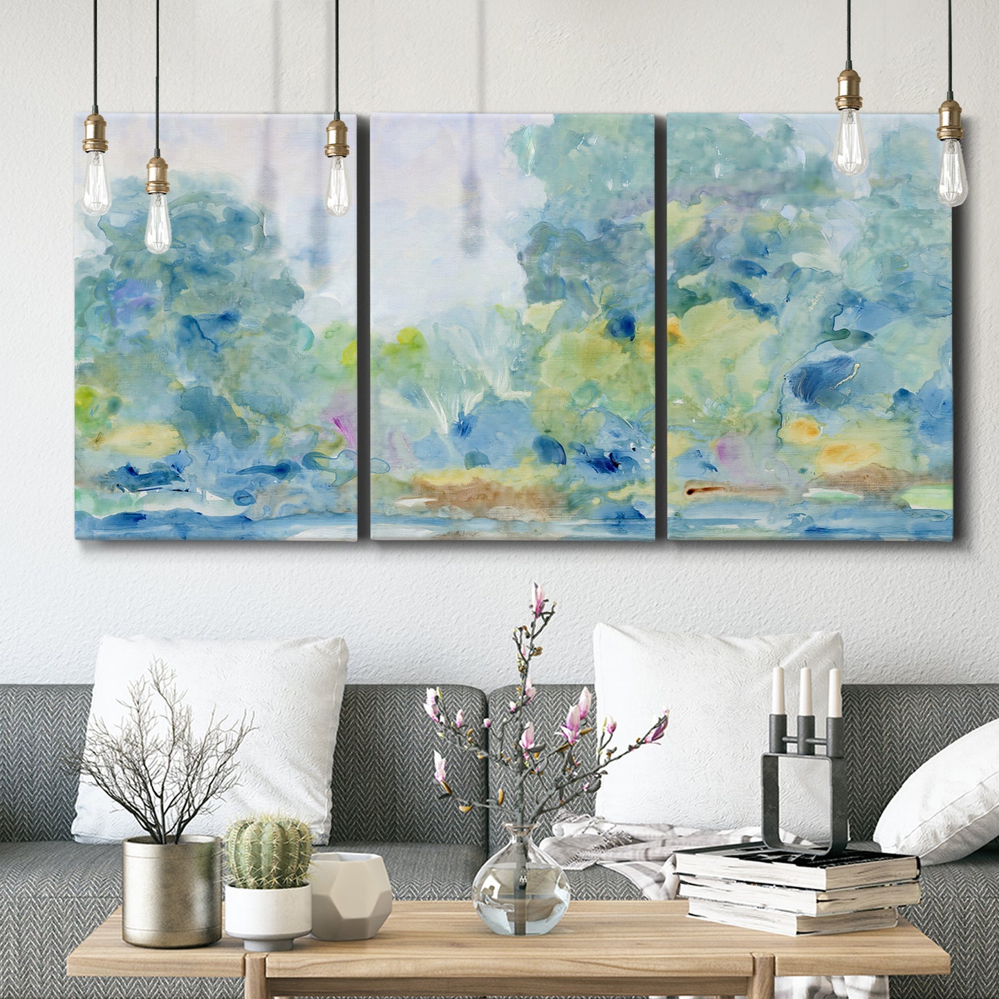 Three-panel canvas wall art featuring quiet abstract morning landscape, displayed in a modern living room above seating.