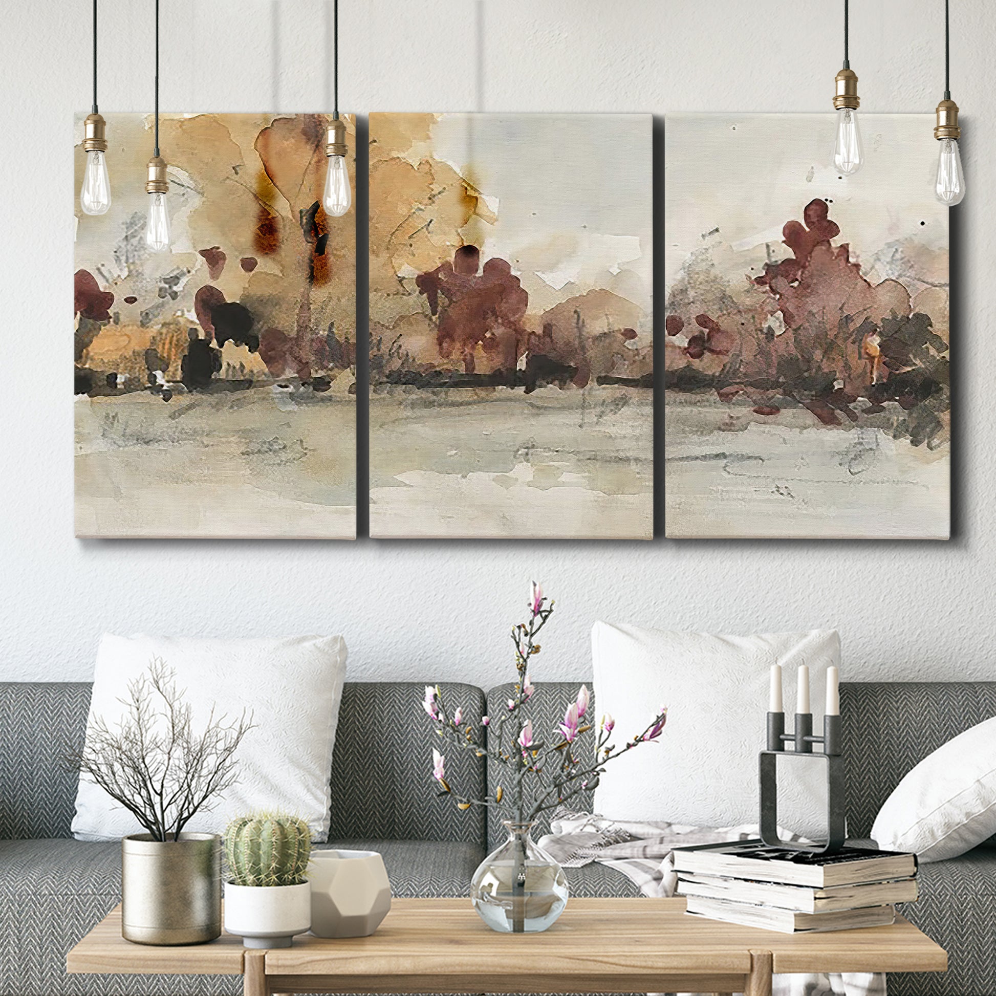 Three-panel canvas wall art featuring autumn landscape with trees and field, displayed in a modern living room above seating.