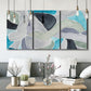 Three-panel canvas wall art featuring subtle abstract billowing color layers, displayed in a modern living room above seating.