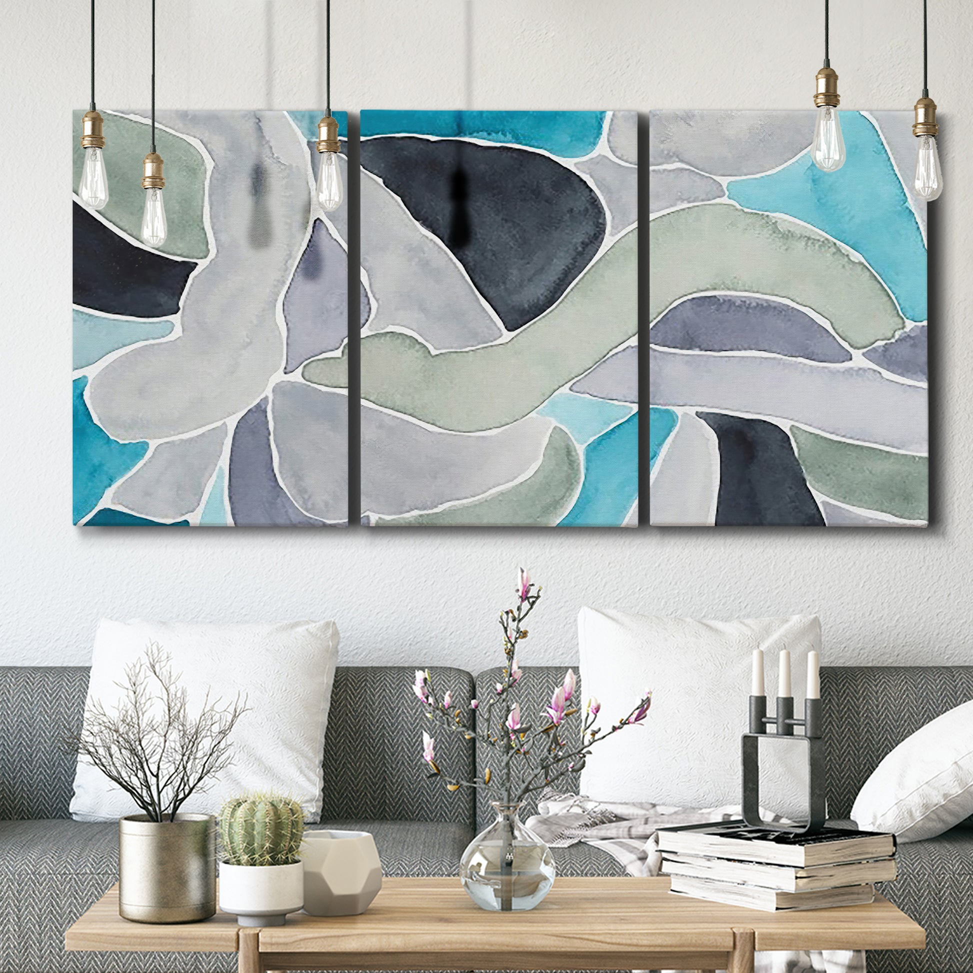 Three-panel canvas wall art featuring subtle abstract billowing color layers, displayed in a modern living room above seating.