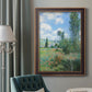 Impressionist pastoral landscape with poppy fields by Claude Monet in an ornate bronzed mahogany wood frame displayed in a dark-toned interior setting.