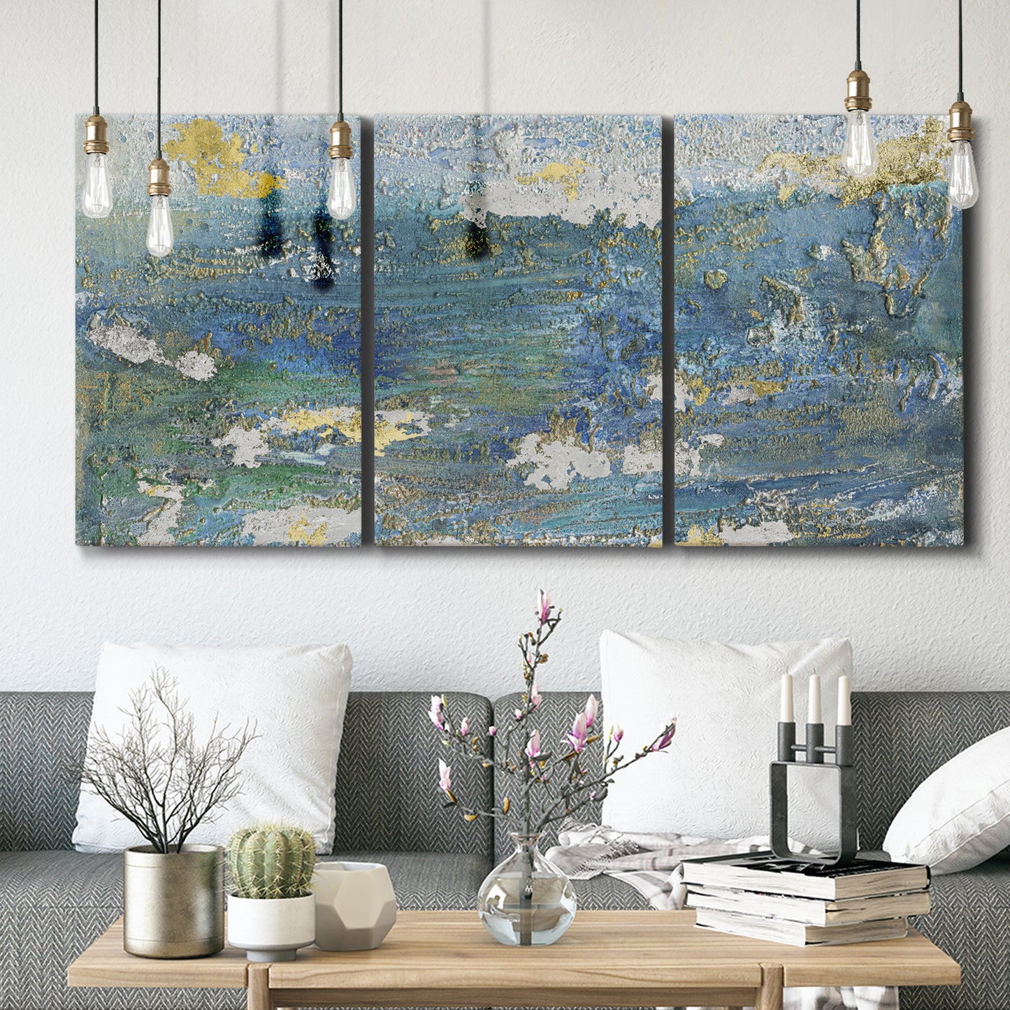Three-panel canvas wall art featuring sparkling abstract sea surface, displayed in a modern living room above seating.