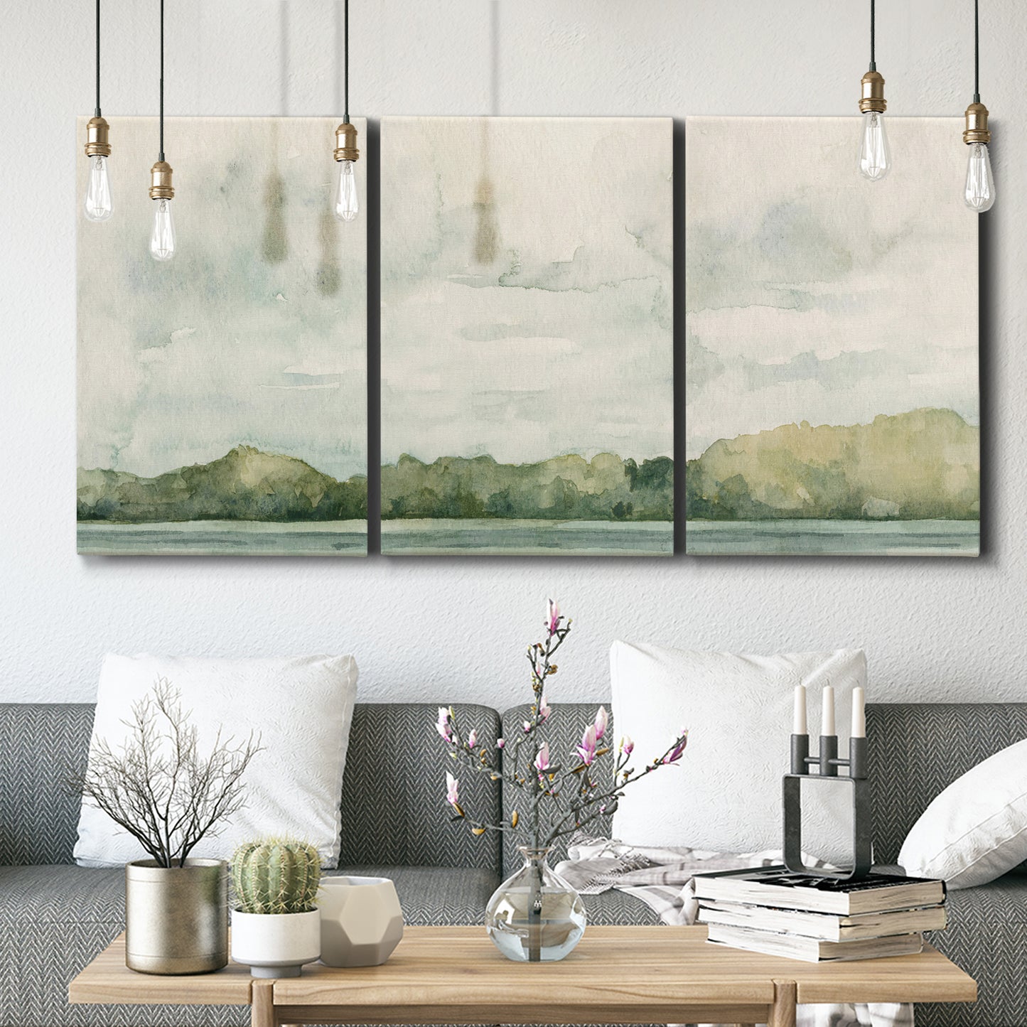 Three-panel canvas wall art featuring riverbank landscape with trees, displayed in a modern living room above seating.