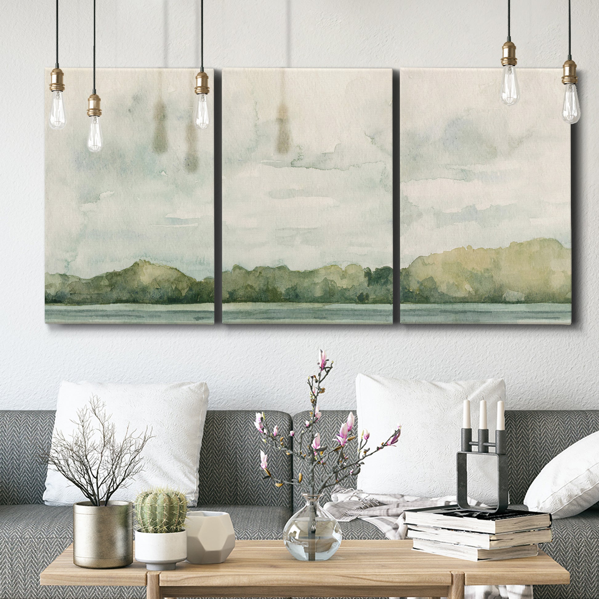 Three-panel canvas wall art featuring riverbank landscape with trees, displayed in a modern living room above seating.