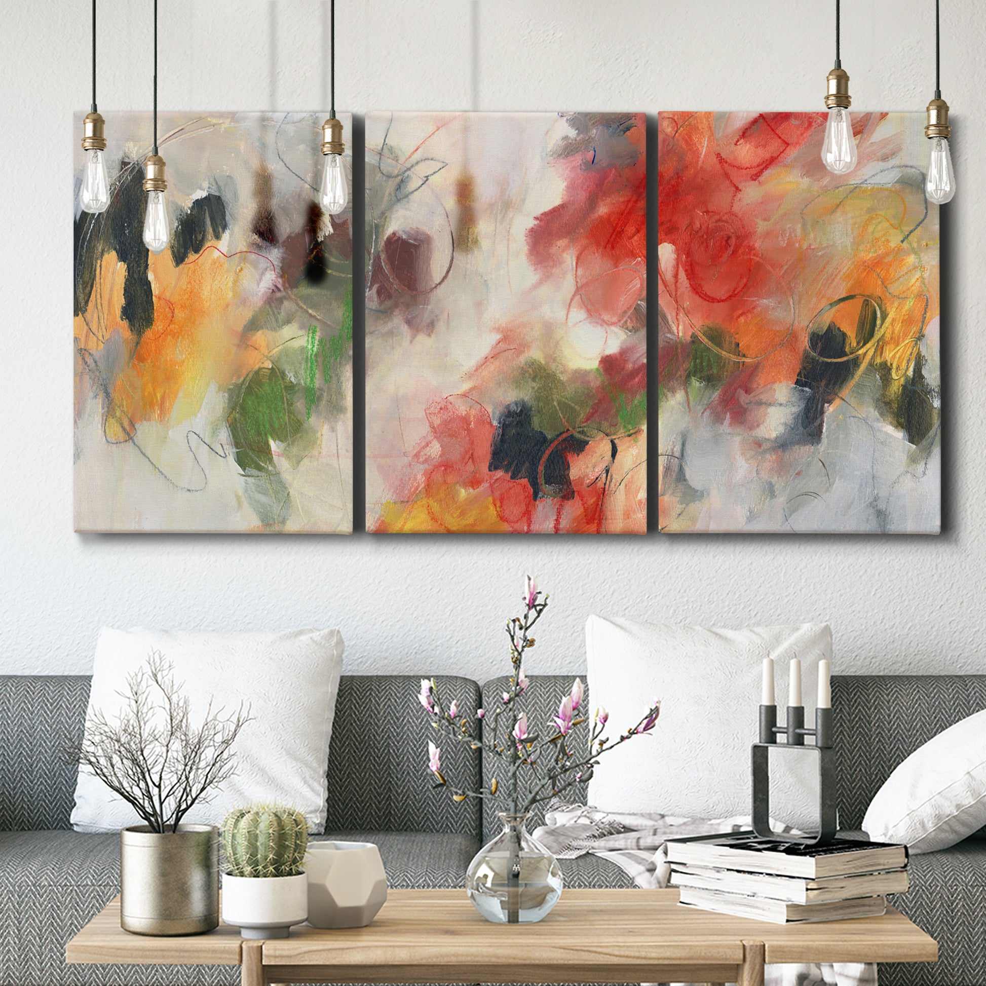 Three-panel canvas wall art featuring abstract floral color composition, displayed in a modern living room above seating.