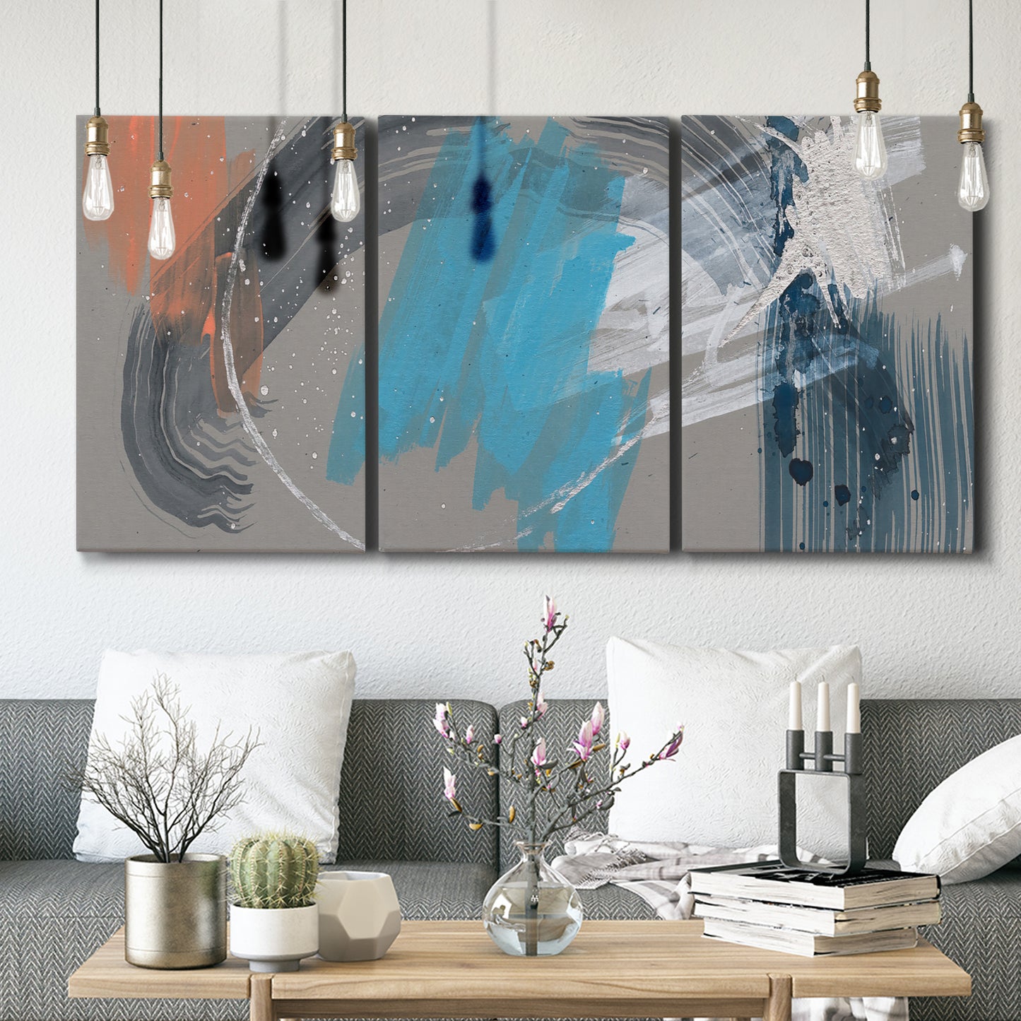 Three-panel canvas wall art featuring playful abstract mark making, displayed in a modern living room above seating.