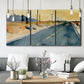 Three-panel canvas wall art featuring empty highway stretching through landscape, displayed in a modern living room above seating.