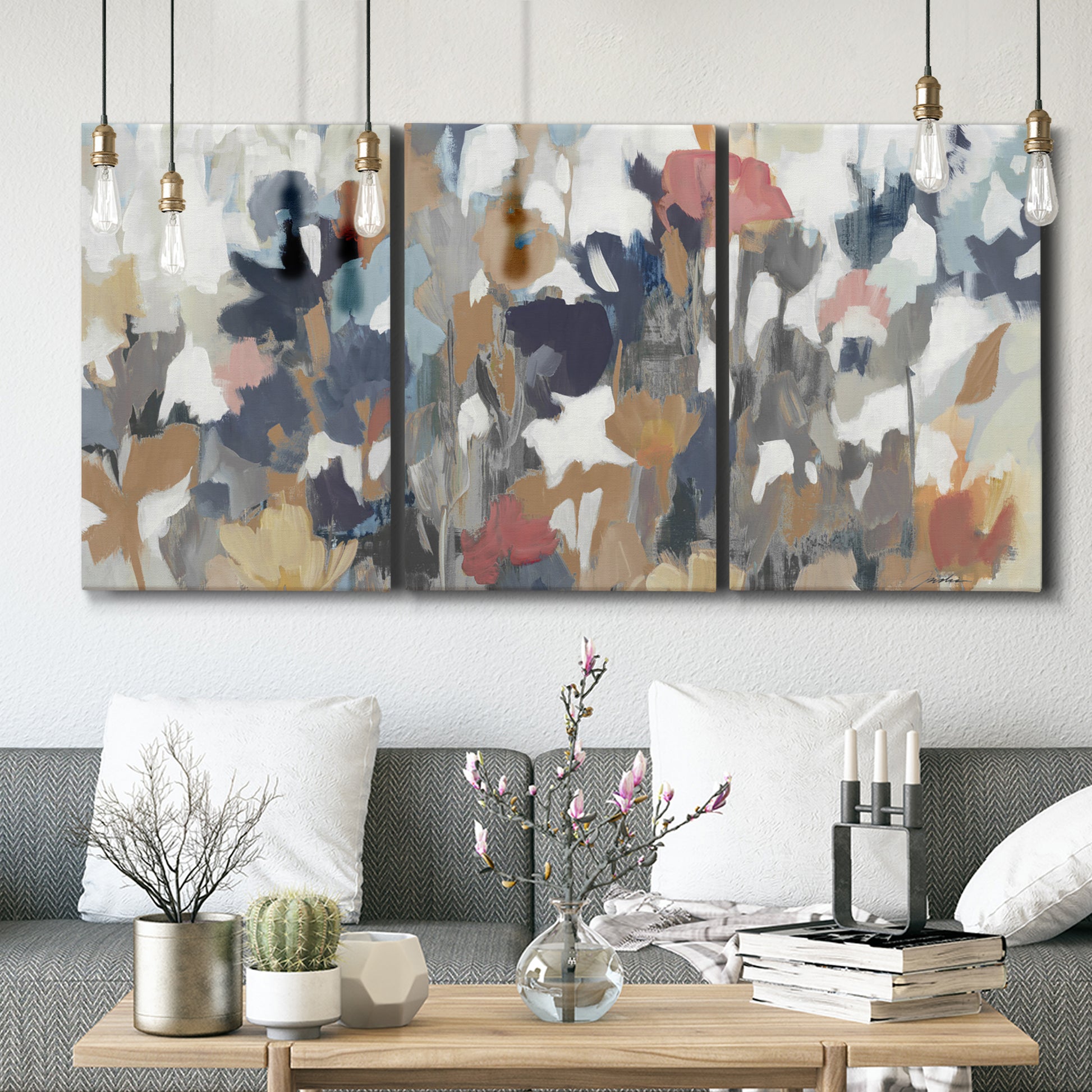 Three-panel canvas wall art featuring abstract flower stand composition, displayed in a modern living room above seating.