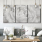 Three-panel canvas wall art featuring monochrome rose study photograph, displayed in a modern living room above seating.