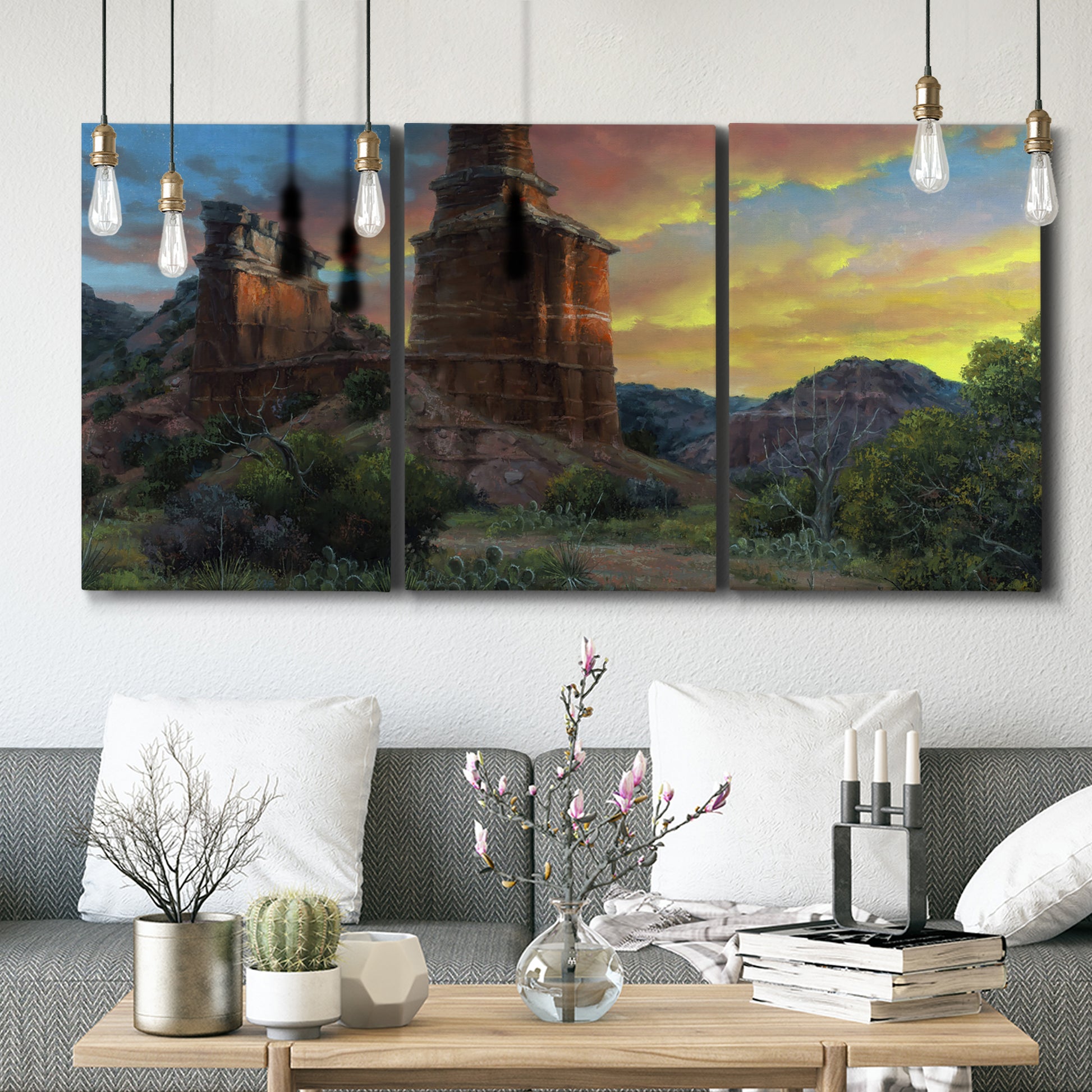 Three-panel canvas wall art featuring dramatic canyon landscape at dusk, displayed in a modern living room above seating.