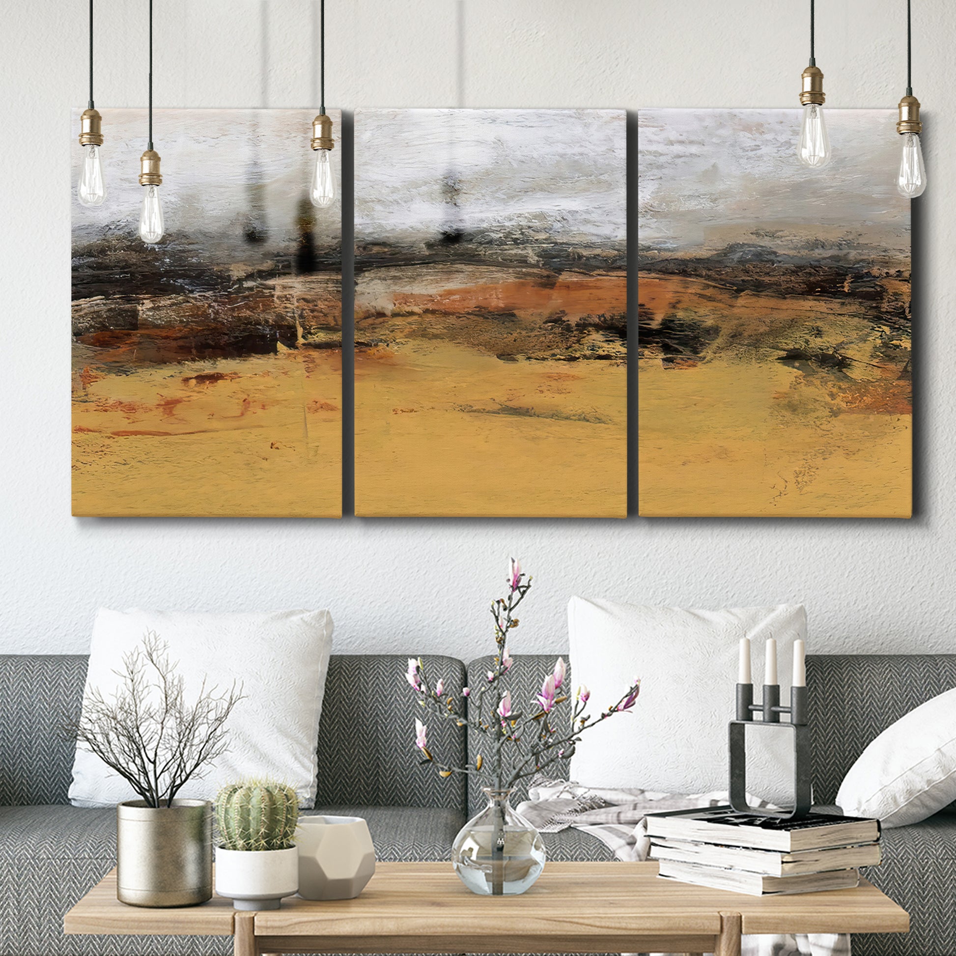 Three-panel canvas wall art featuring abstract bridge landscape in ochre, displayed in a modern living room above seating.