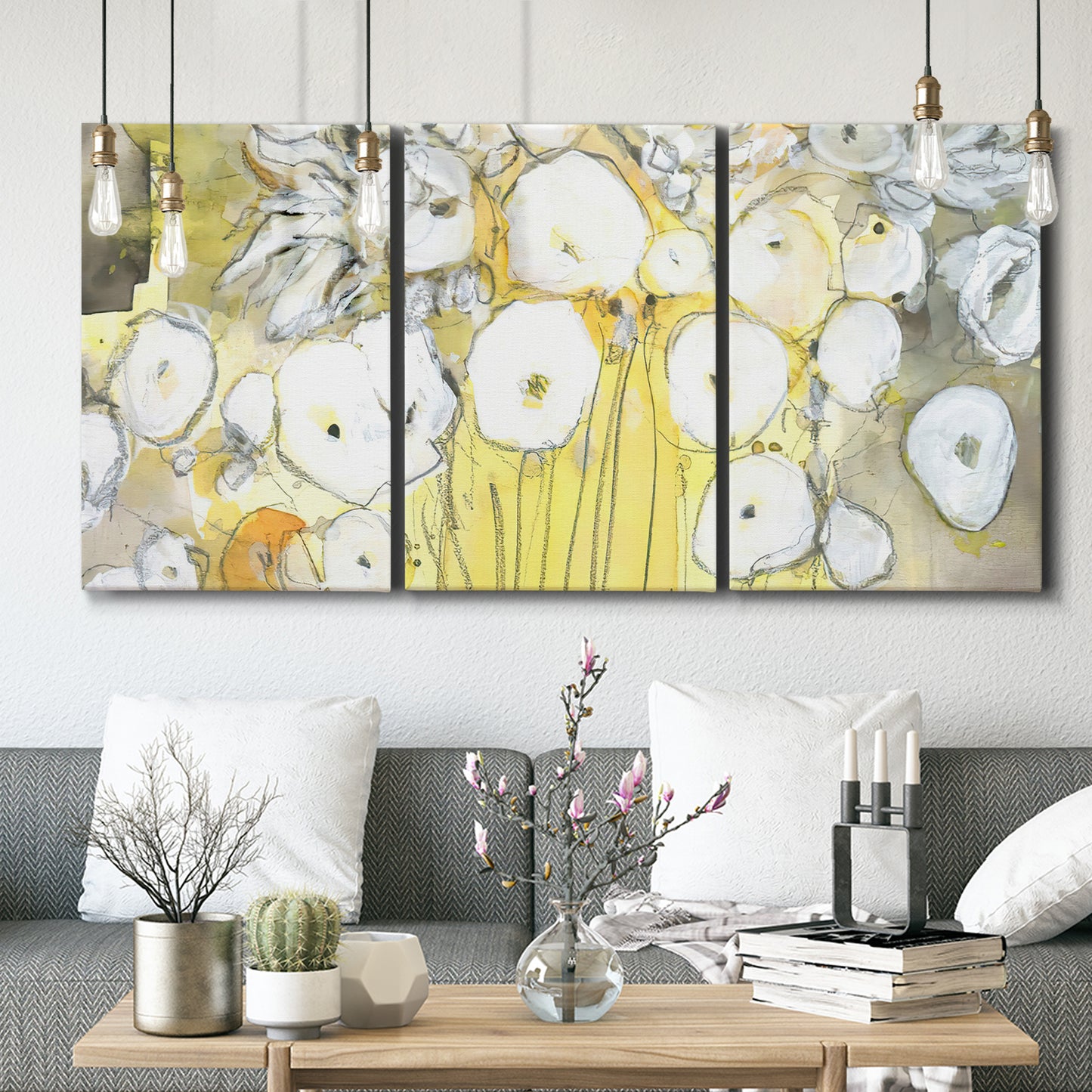 Three-panel canvas wall art featuring vintage inspired floral abstraction, displayed in a modern living room above seating.