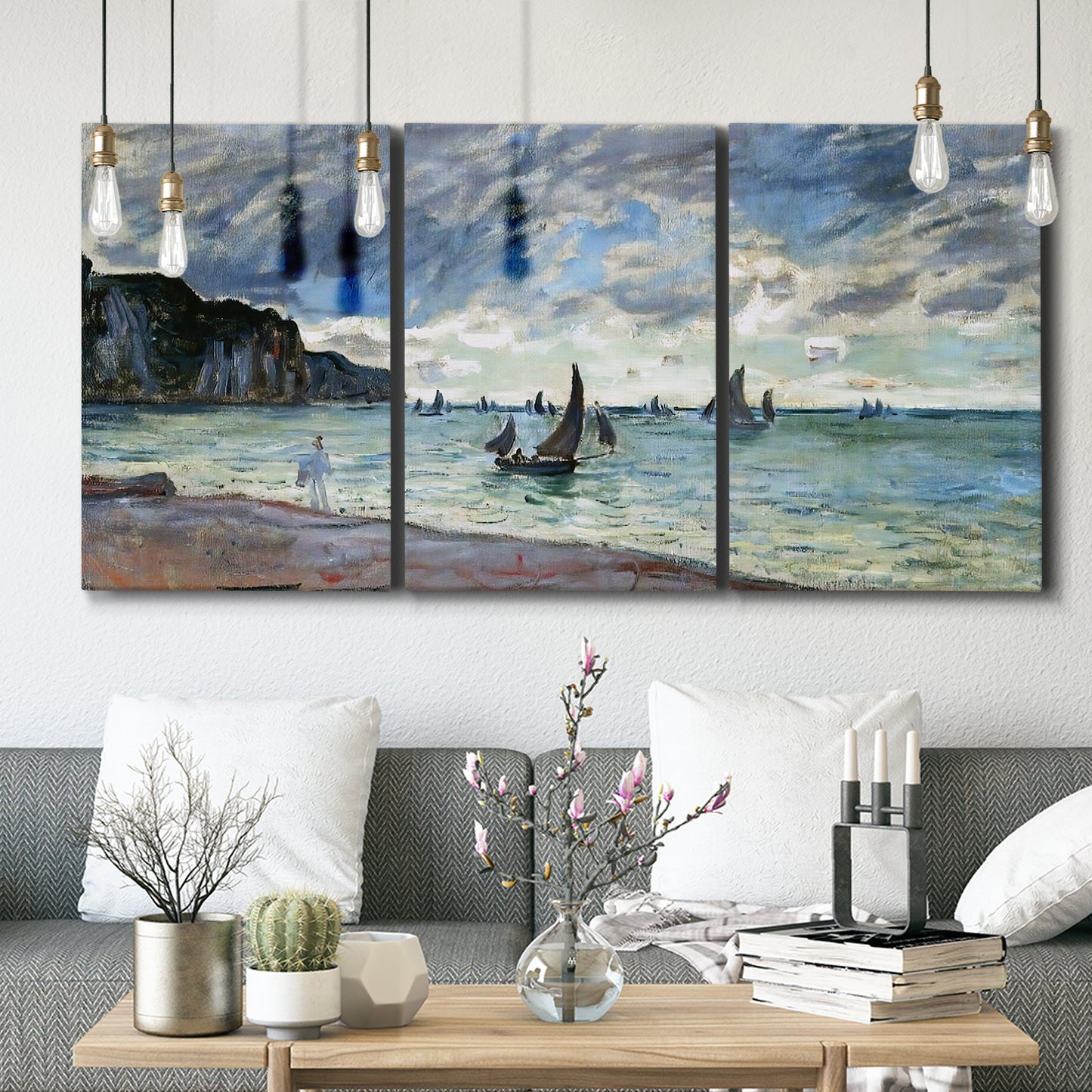 Three-panel canvas wall art featuring figures walking along sandy shoreline, displayed in a modern living room above seating.