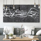 Three-panel canvas wall art featuring minimal abstract frequency lines, displayed in a modern living room above seating.