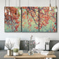 Three-panel canvas wall art featuring autumn foliage landscape photograph, displayed in a modern living room above seating.