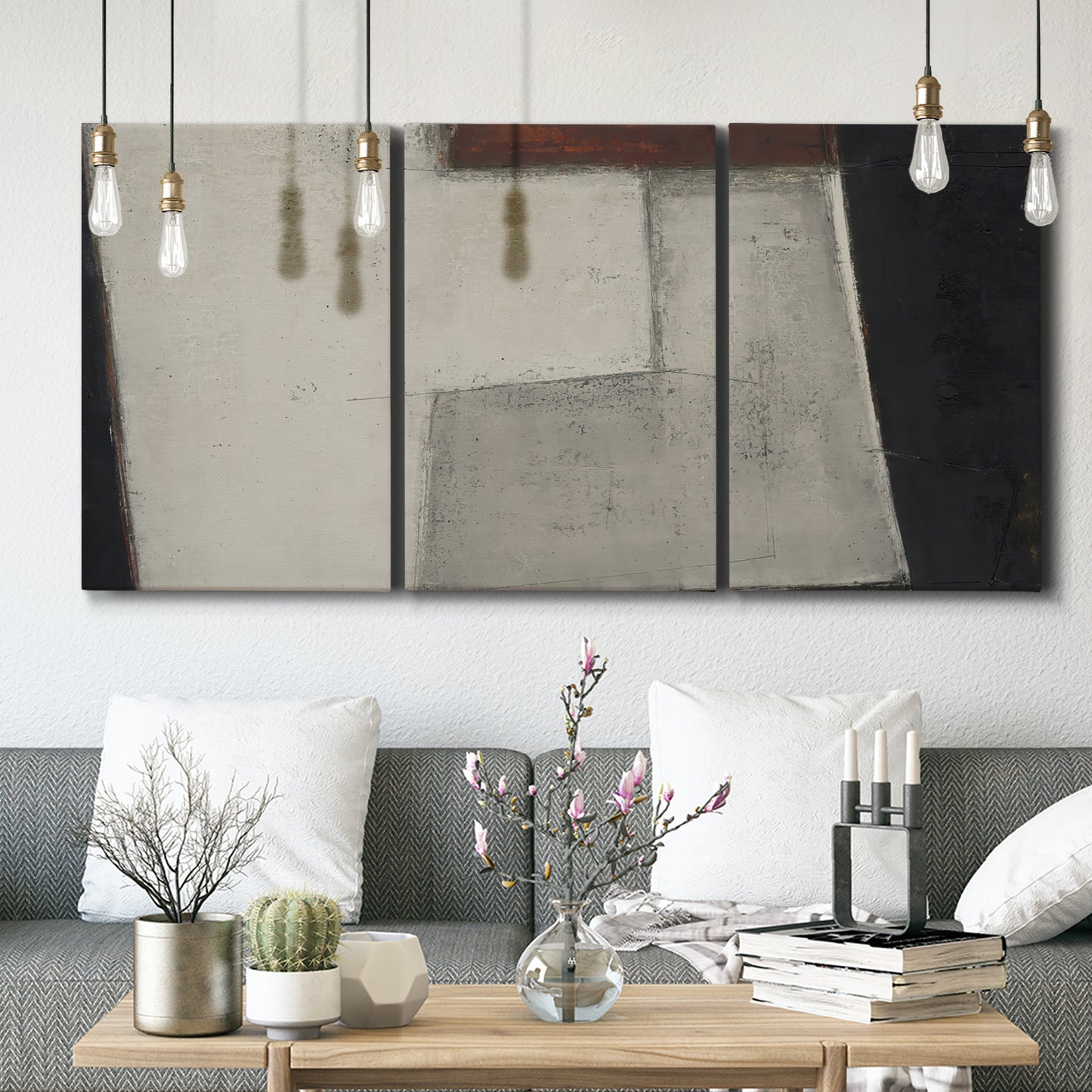Three-panel canvas wall art featuring geometric abstract roadway motif, displayed in a modern living room above seating.