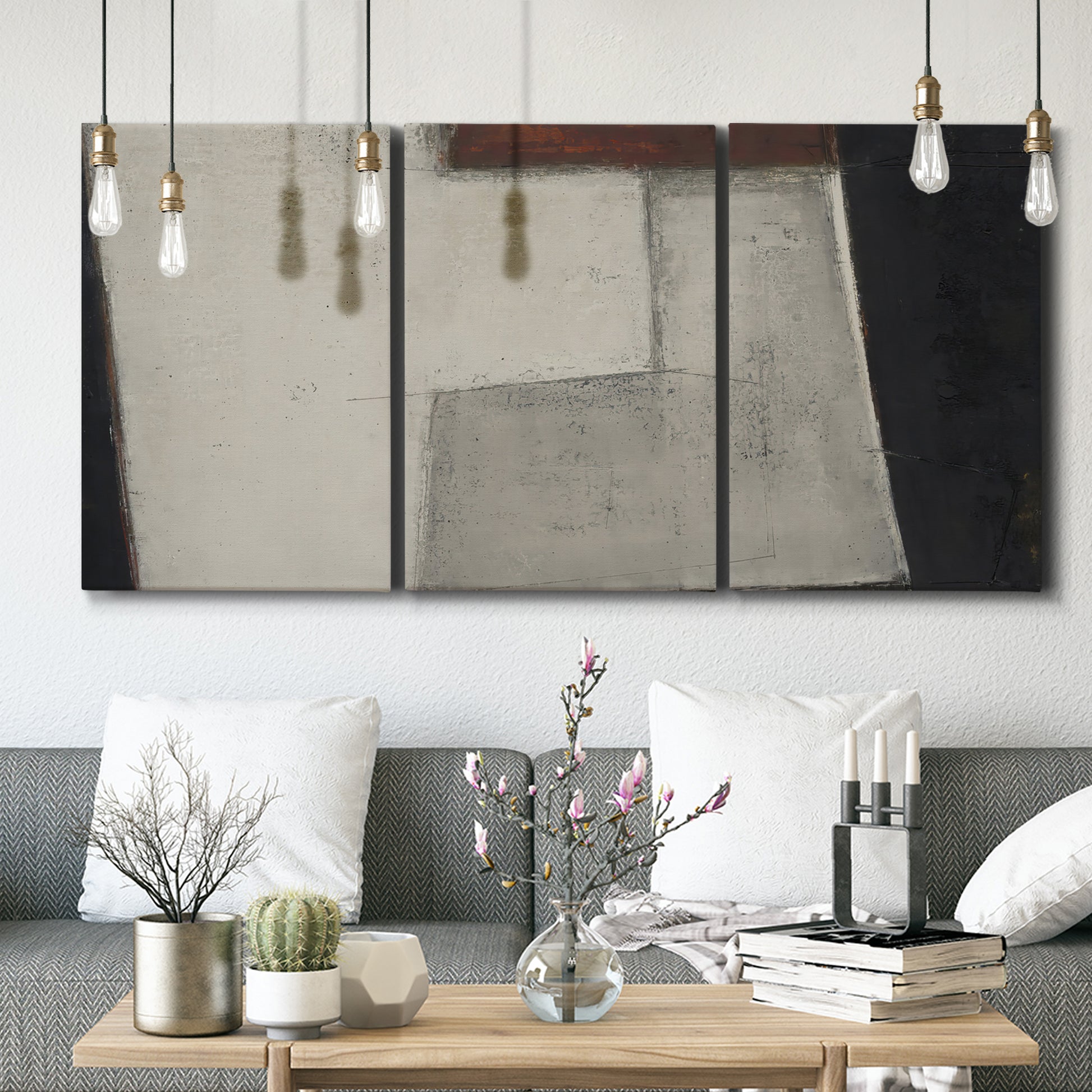 Three-panel canvas wall art featuring geometric abstract roadway motif, displayed in a modern living room above seating.