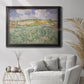 Impressionist countryside landscape near Auvers by Vincent van Gogh in an ornate black frame with gilded inner detail displayed in a bright interior setting.