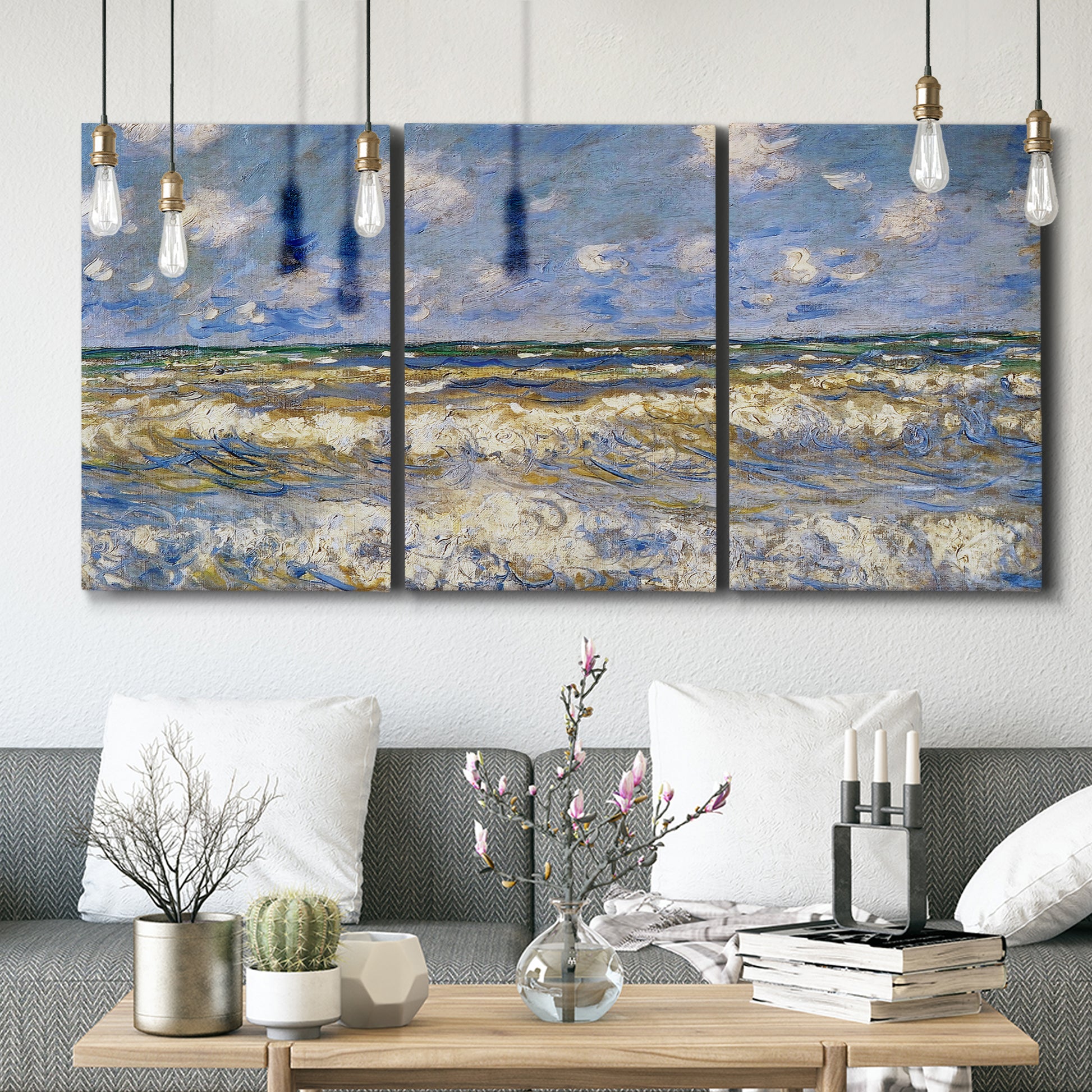Three-panel canvas wall art featuring rough sea with crashing waves, displayed in a modern living room above seating.