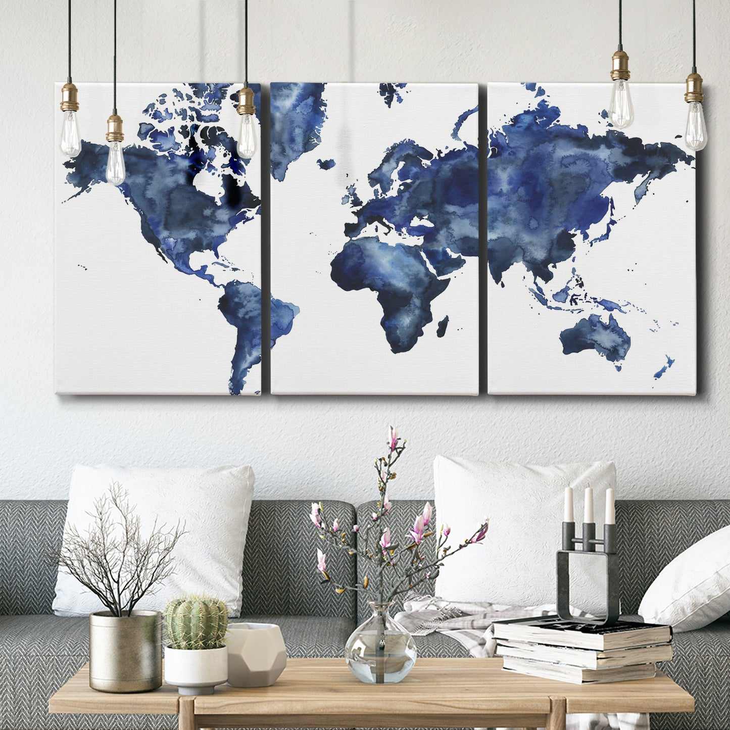 Three-panel canvas wall art featuring world map with water motif, displayed in a modern living room above seating.