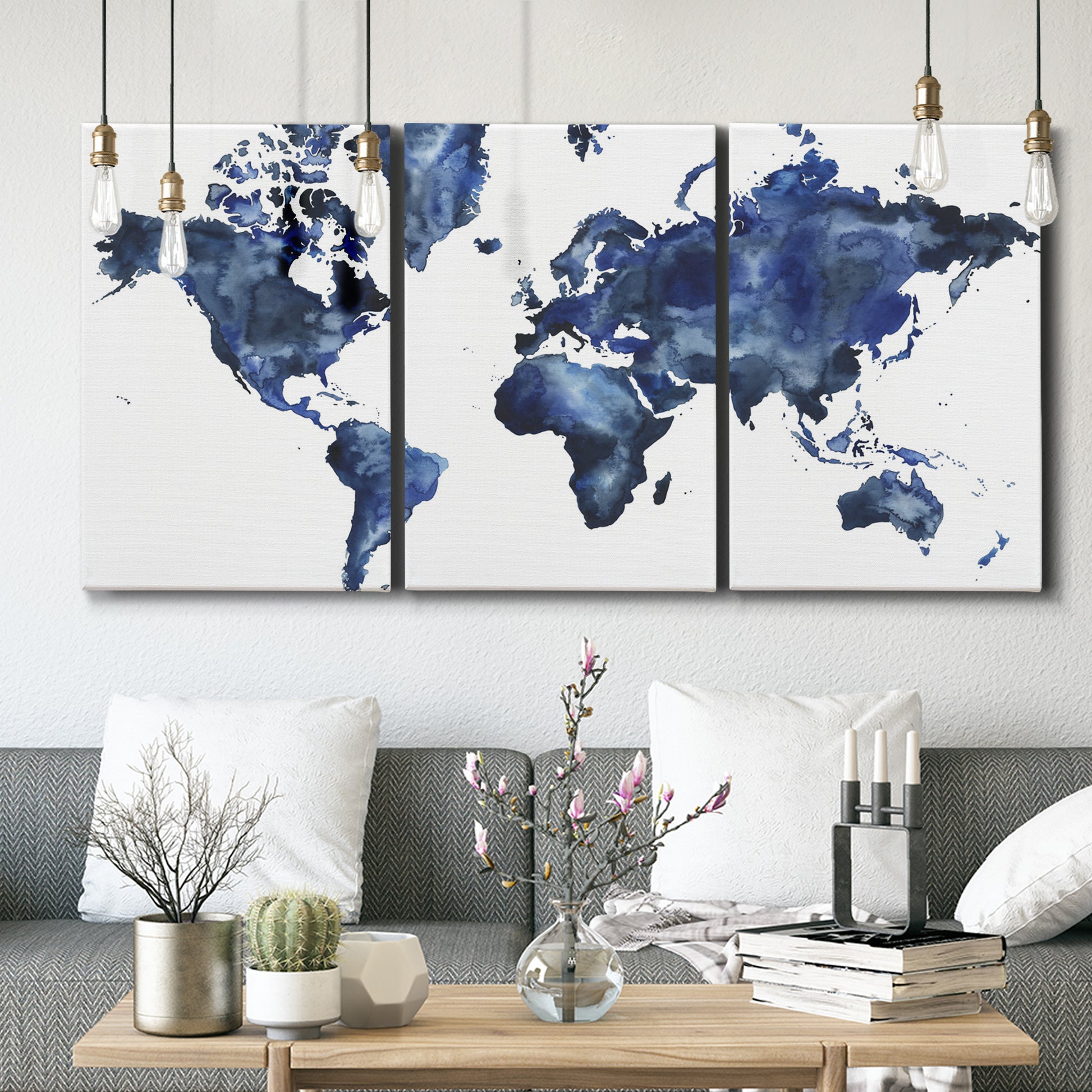 Three-panel canvas wall art featuring world map with water motif, displayed in a modern living room above seating.