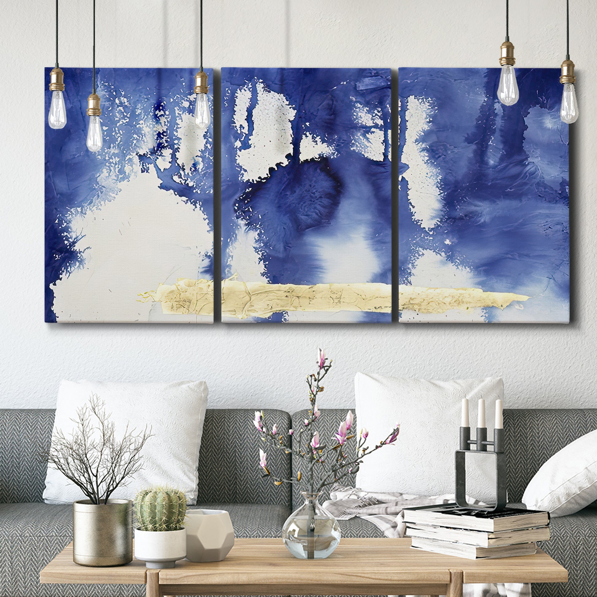 Three-panel canvas wall art featuring saturated abstract color fields, displayed in a modern living room above seating.