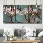 Three-panel canvas wall art featuring dogwood blossoms in spring photograph, displayed in a modern living room above seating.