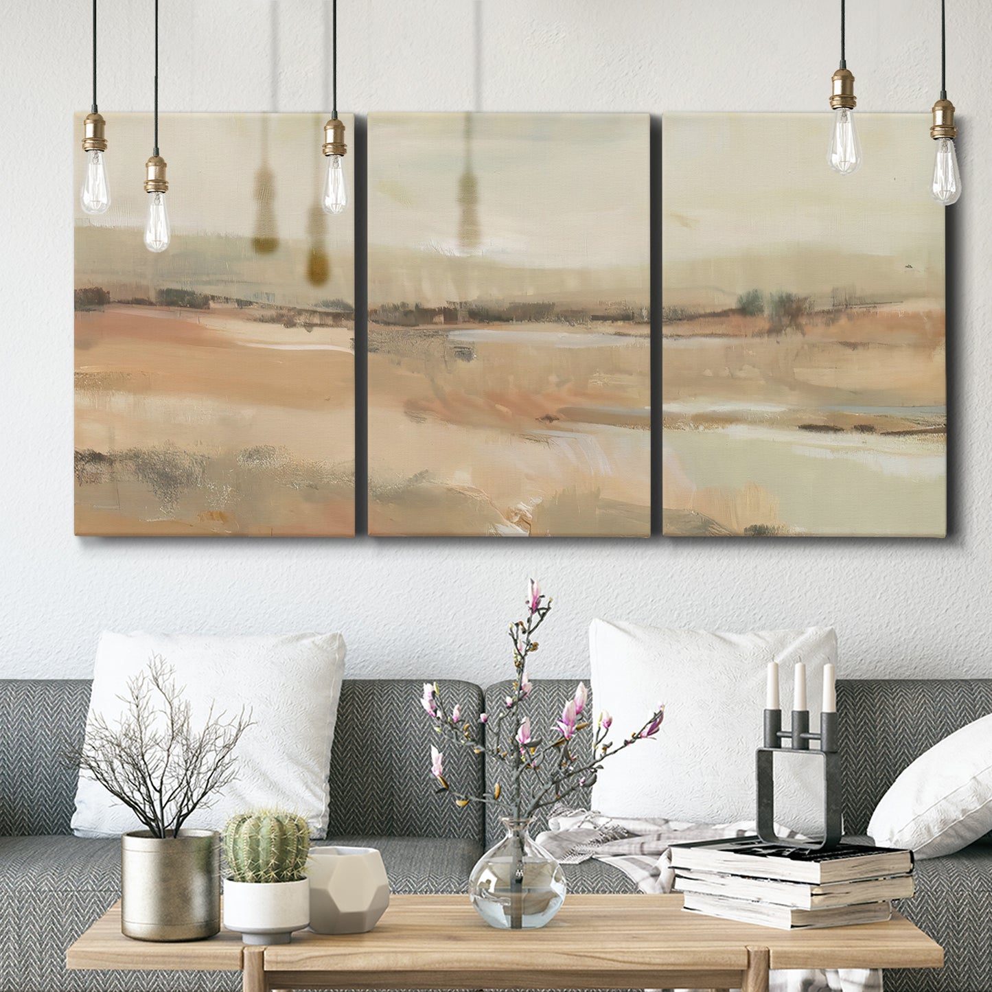 Three-panel canvas wall art featuring earth toned abstract landscape, displayed in a modern living room above seating.