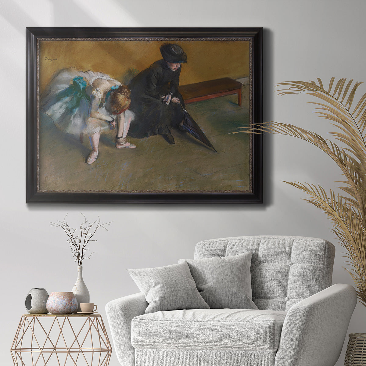 Impressionist portrait of a seated woman by Edgar Degas in an ornate black frame with gilded inner detail displayed in a bright interior setting.