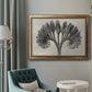 Vintage botanical plant study photograph by Karl Blossfeldt in an ornate vintage gold frame displayed in a neutral interior setting.