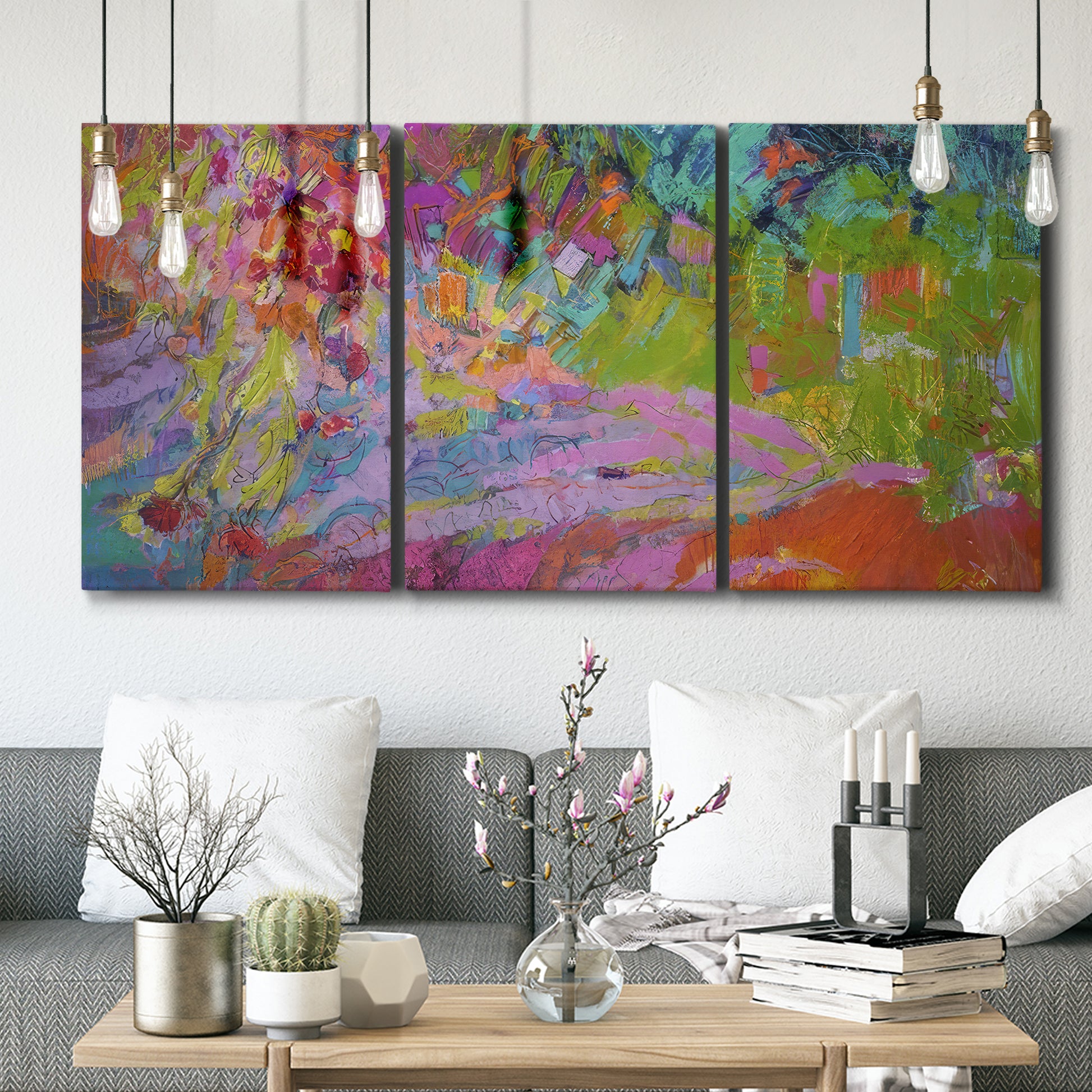 Three-panel canvas wall art featuring vibrant abstract with dramatic motion, displayed in a modern living room above seating.