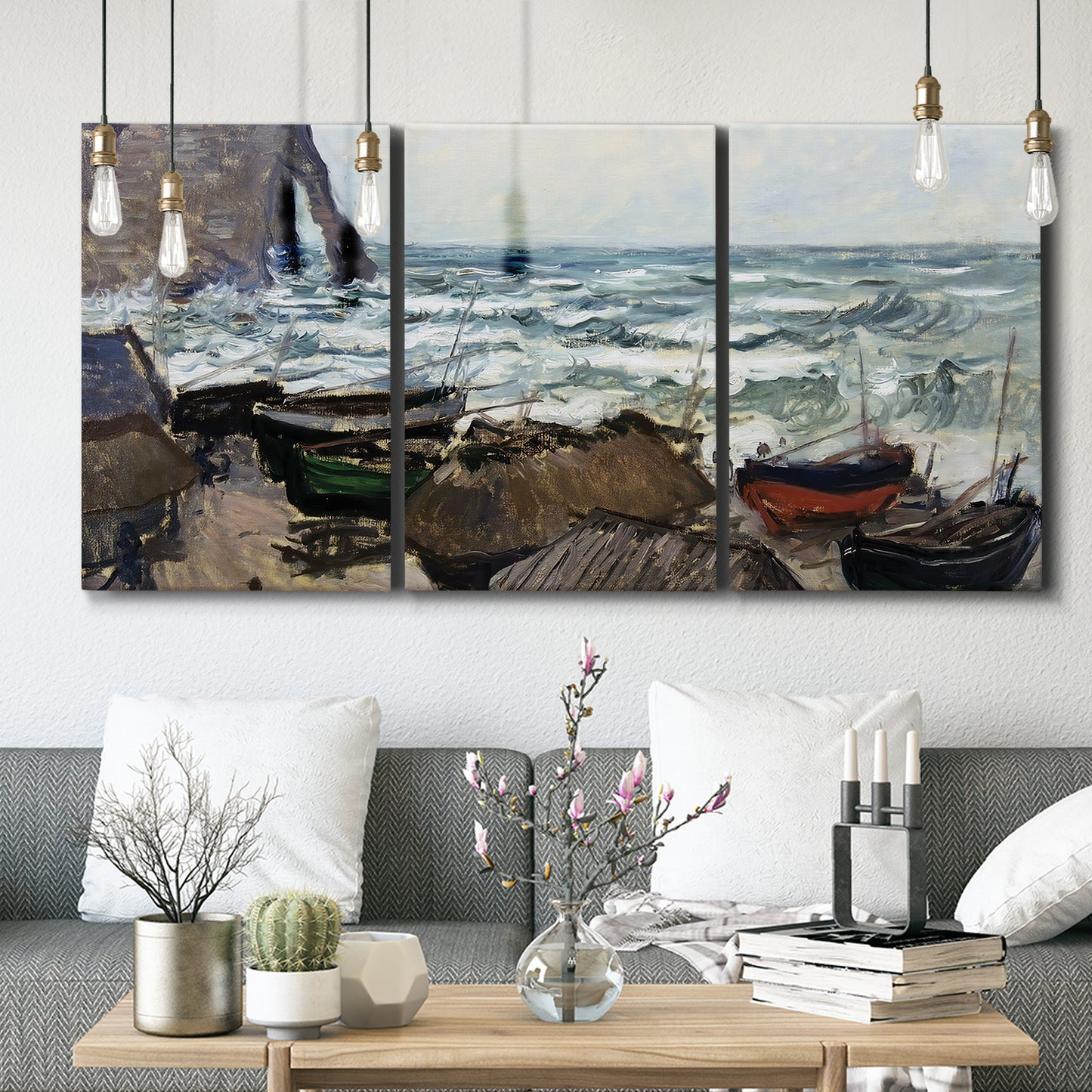 Three-panel canvas wall art featuring rough coastal seas under storm clouds, displayed in a modern living room above seating.
