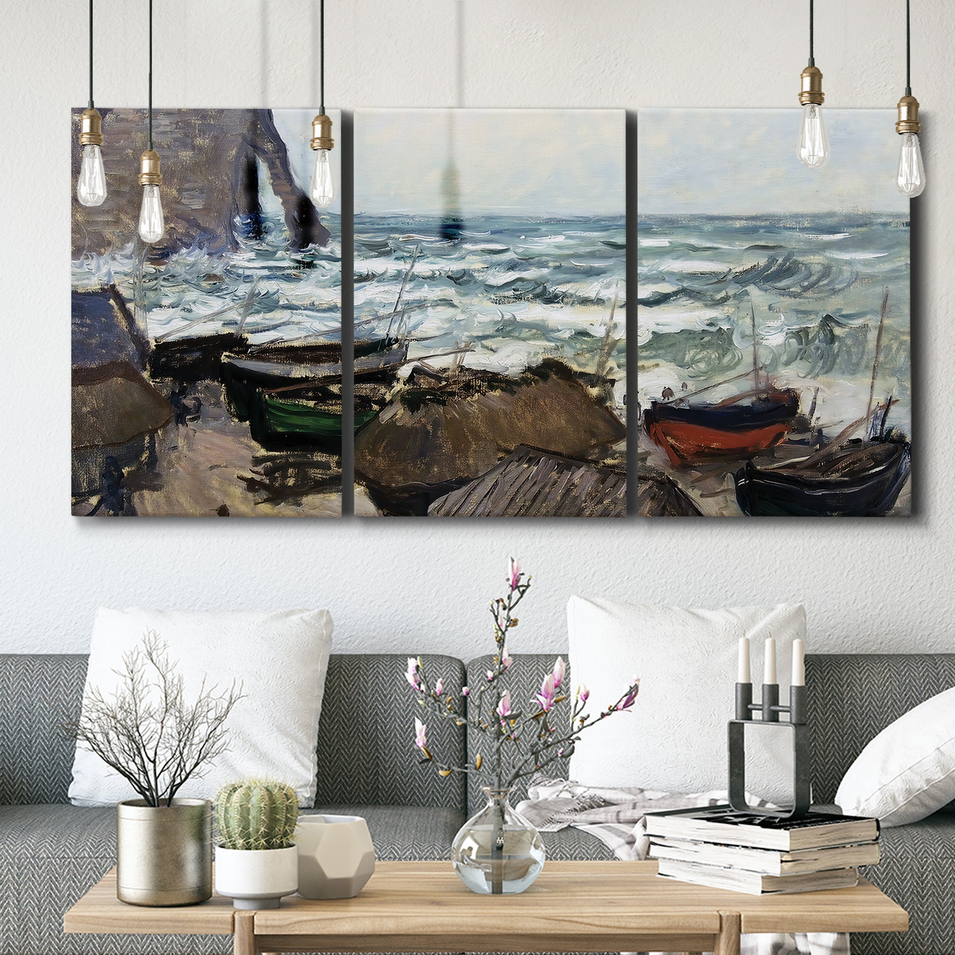 Three-panel canvas wall art featuring rough coastal seas under storm clouds, displayed in a modern living room above seating.