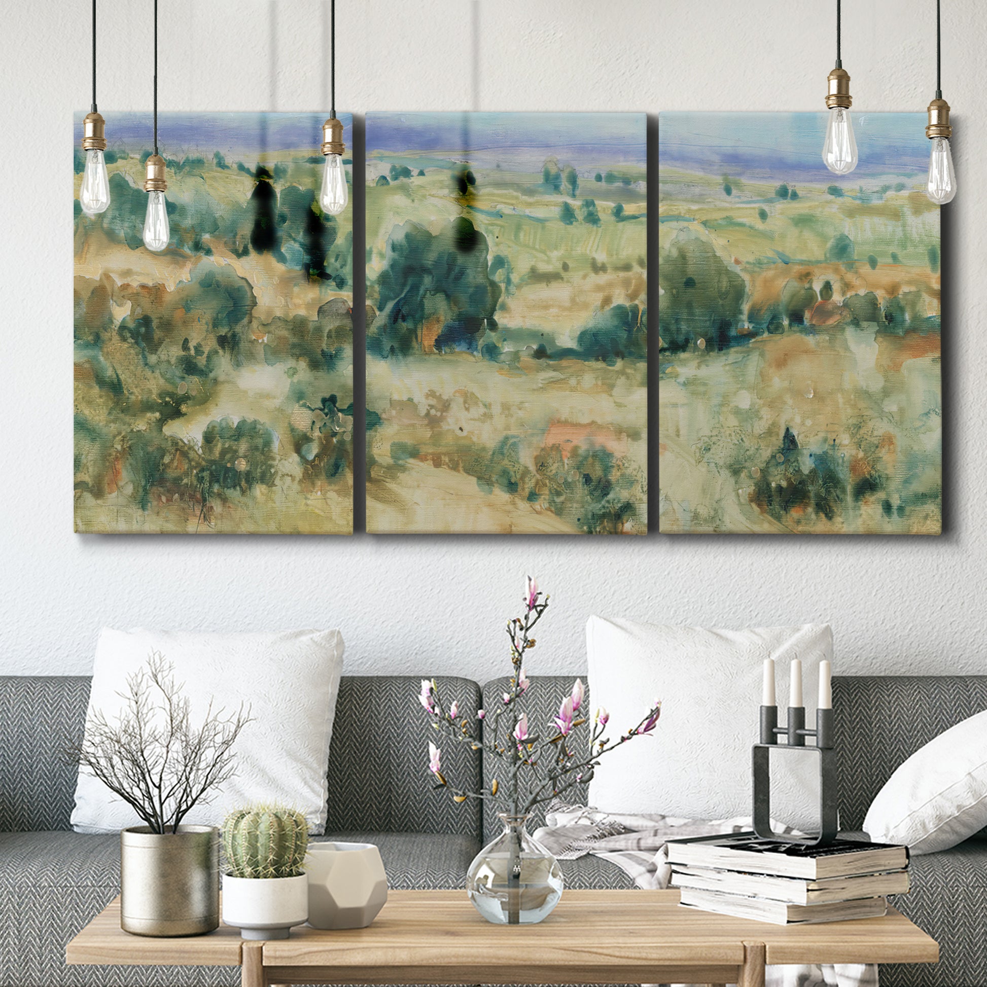 Three-panel canvas wall art featuring lavender sky over quiet landscape, displayed in a modern living room above seating.