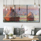 Three-panel canvas wall art featuring winter grainstacks glowing at sunset, displayed in a modern living room above seating.