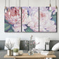 Three-panel canvas wall art featuring soft pink peonies in bloom, displayed in a modern living room above seating.