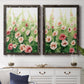 Set of two black barnwood framed canvas prints depicting a coordinated art pair of a field of pink coral and white flowers rendered as luminous impressionistic floral paintings above a dining room sideboard.