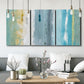 Three-panel canvas wall art featuring abstract coastal beach textures, displayed in a modern living room above seating.