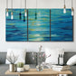 Three-panel canvas wall art featuring deep blue ocean water abstraction, displayed in a modern living room above seating.
