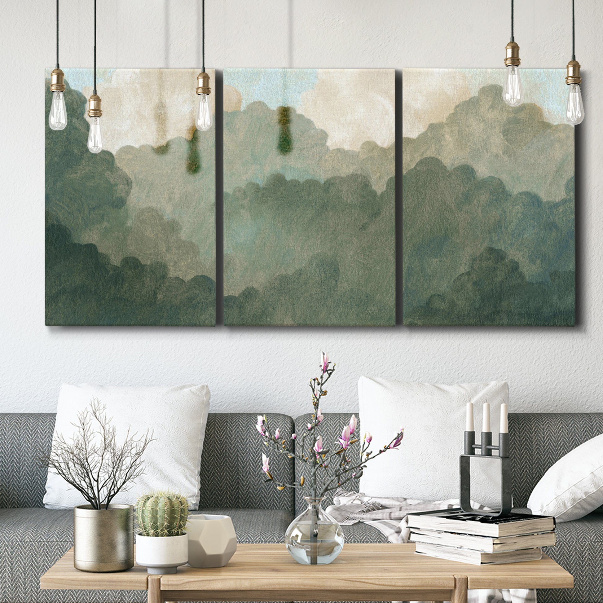 Three-panel canvas wall art featuring autumn storm over rolling landscape, displayed in a modern living room above seating.