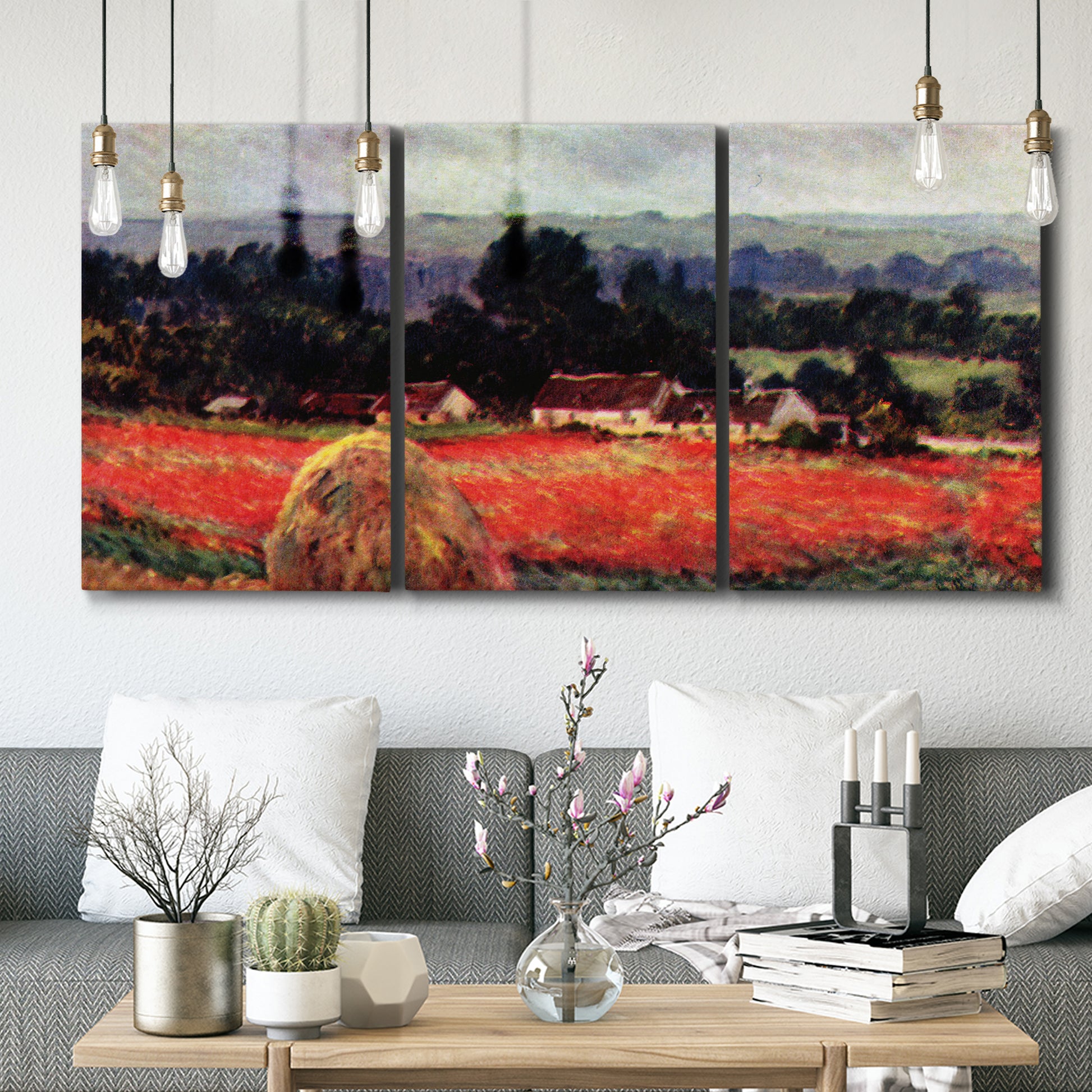 Three-panel canvas wall art featuring red poppy field near barn, displayed in a modern living room above seating.