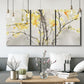 Three-panel canvas wall art featuring soft floral abstract harmony, displayed in a modern living room above seating.