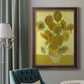 Impressionist sunflower still life painting by Vincent van Gogh in an ornate bronzed mahogany wood frame displayed in a dark-toned interior setting.
