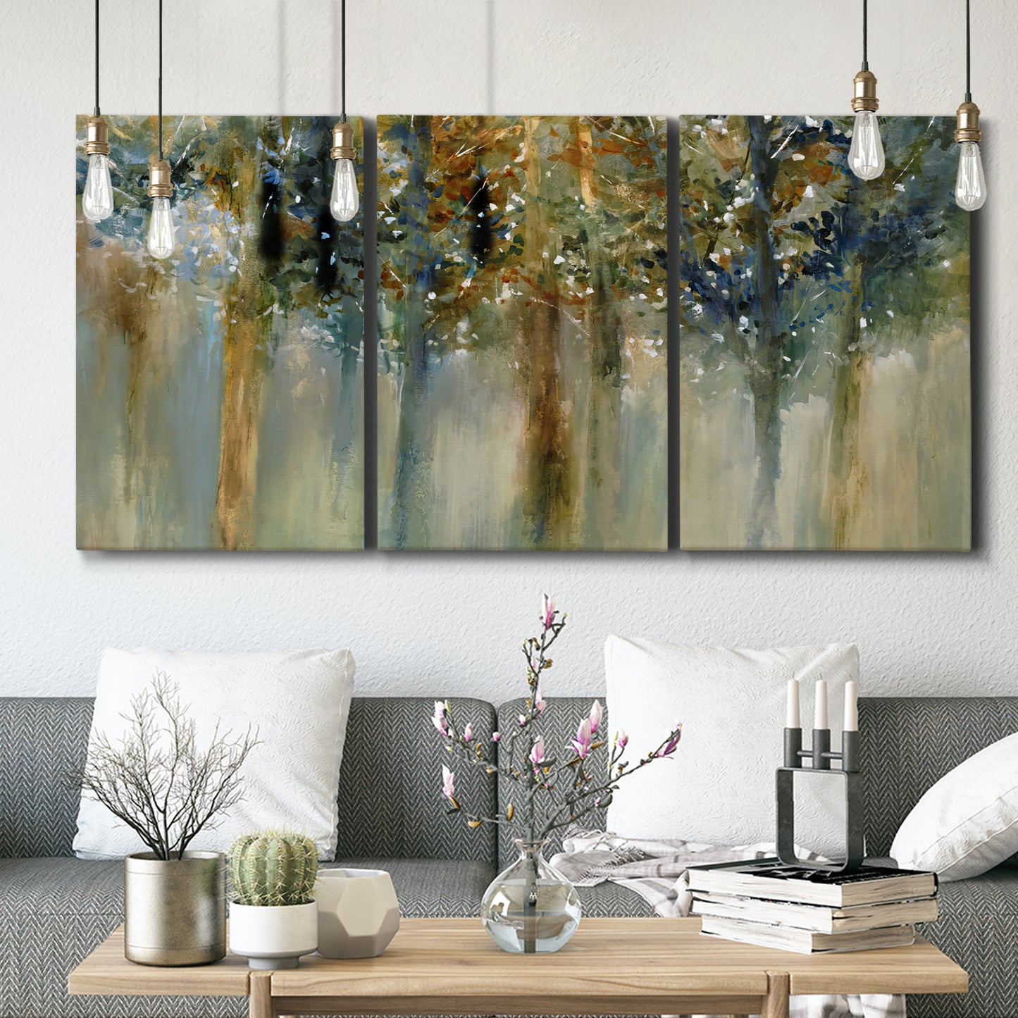 Three-panel canvas wall art featuring earth toned abstract leaf textures, displayed in a modern living room above seating.