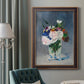 Impressionist floral still life painting by Claude Monet in an ornate bronzed mahogany wood frame displayed in a dark-toned interior setting.
