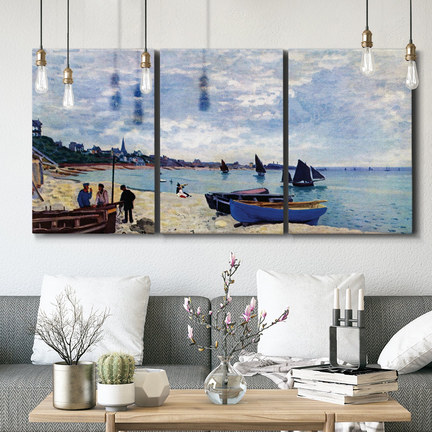 Three-panel canvas wall art featuring busy beach scene with shoreline, displayed in a modern living room above seating.