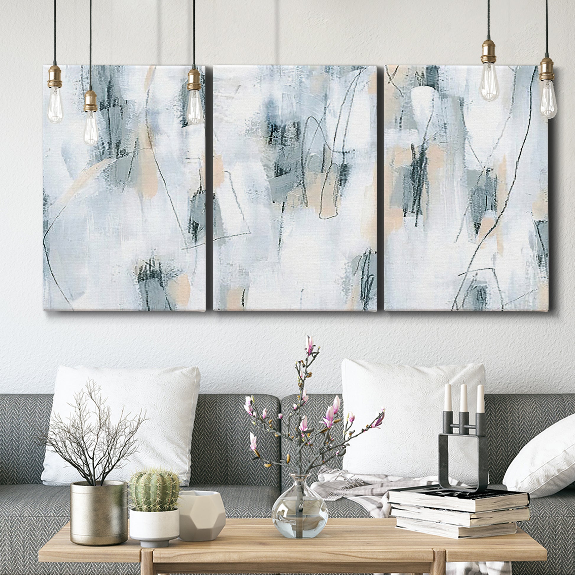 Three-panel canvas wall art featuring industrial textured abstract hatch patterns, displayed in a modern living room above seating.