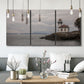 Three-panel canvas wall art featuring lighthouse watching over coastline, displayed in a modern living room above seating.