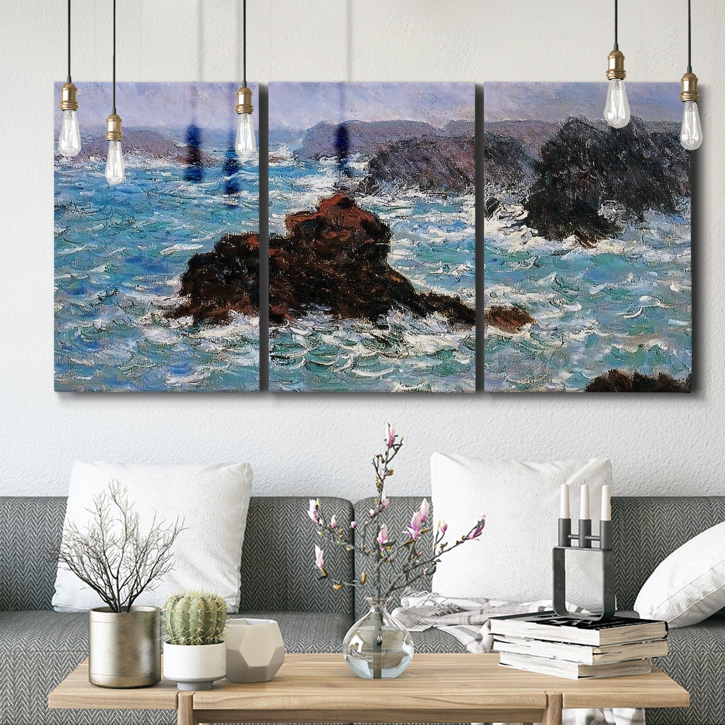 Three-panel canvas wall art featuring storm waves battering rocky coast, displayed in a modern living room above seating.