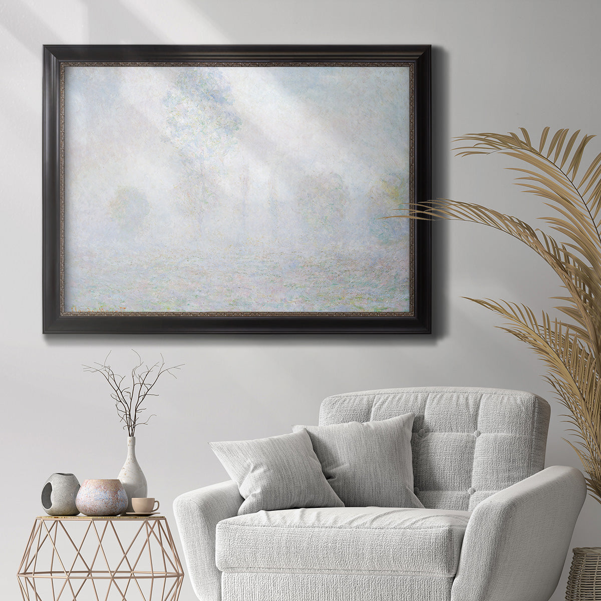 Impressionist atmospheric landscape in morning haze by Claude Monet in an ornate black frame with gilded inner detail displayed in a bright interior setting.